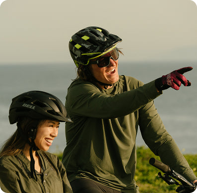 Man and woman wearing mountain bike helmets with Aleck devices