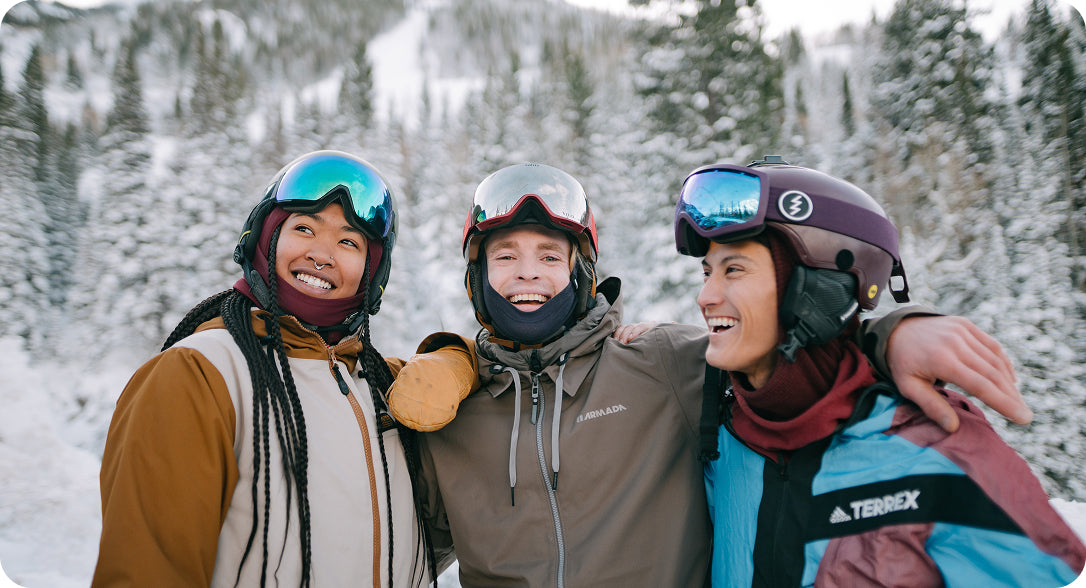 Group of skiers in snowy forest, wearing ski helmets with Aleck audio systems