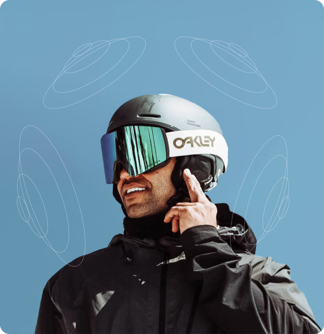 Snowboarder adjusting Aleck Nunchucks audio device