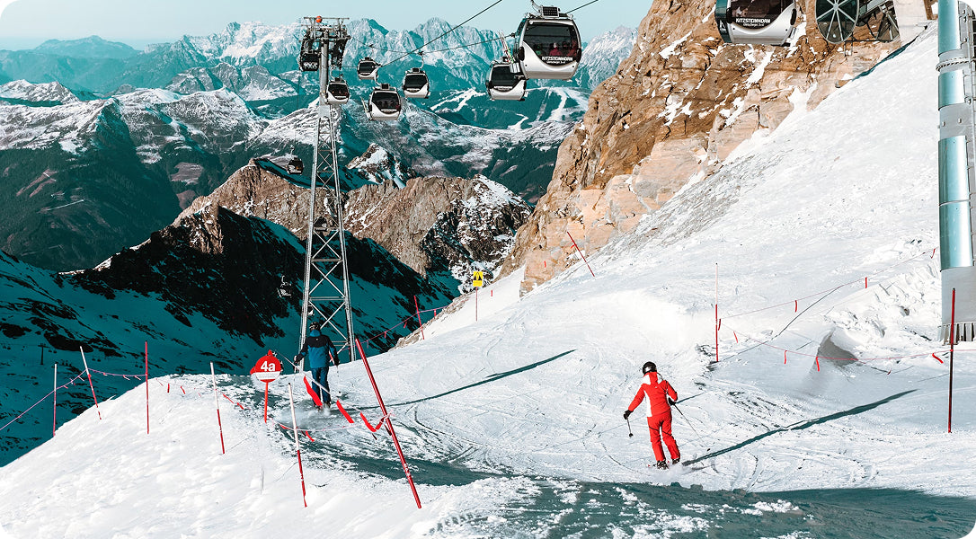 Skiers riding down mountain slope, representing the origin story of Aleck's group communication system