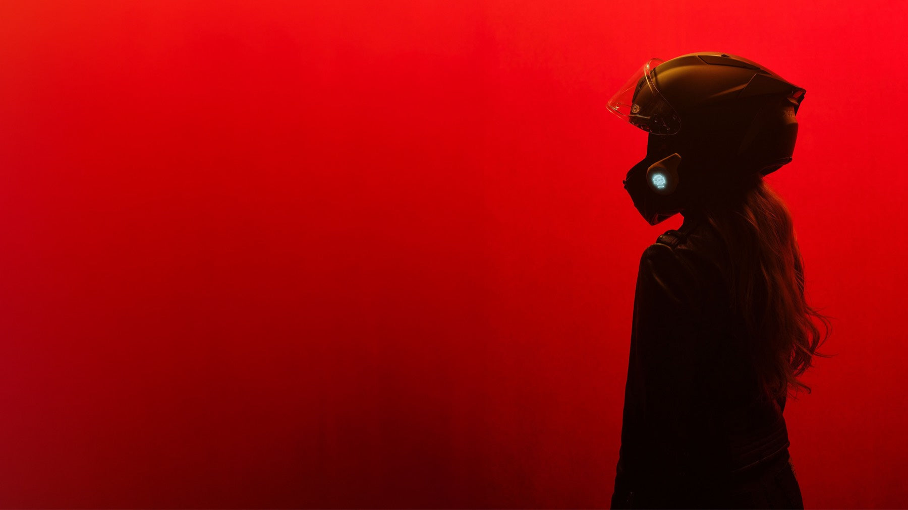 99ONE rider in helmet on red backdrop