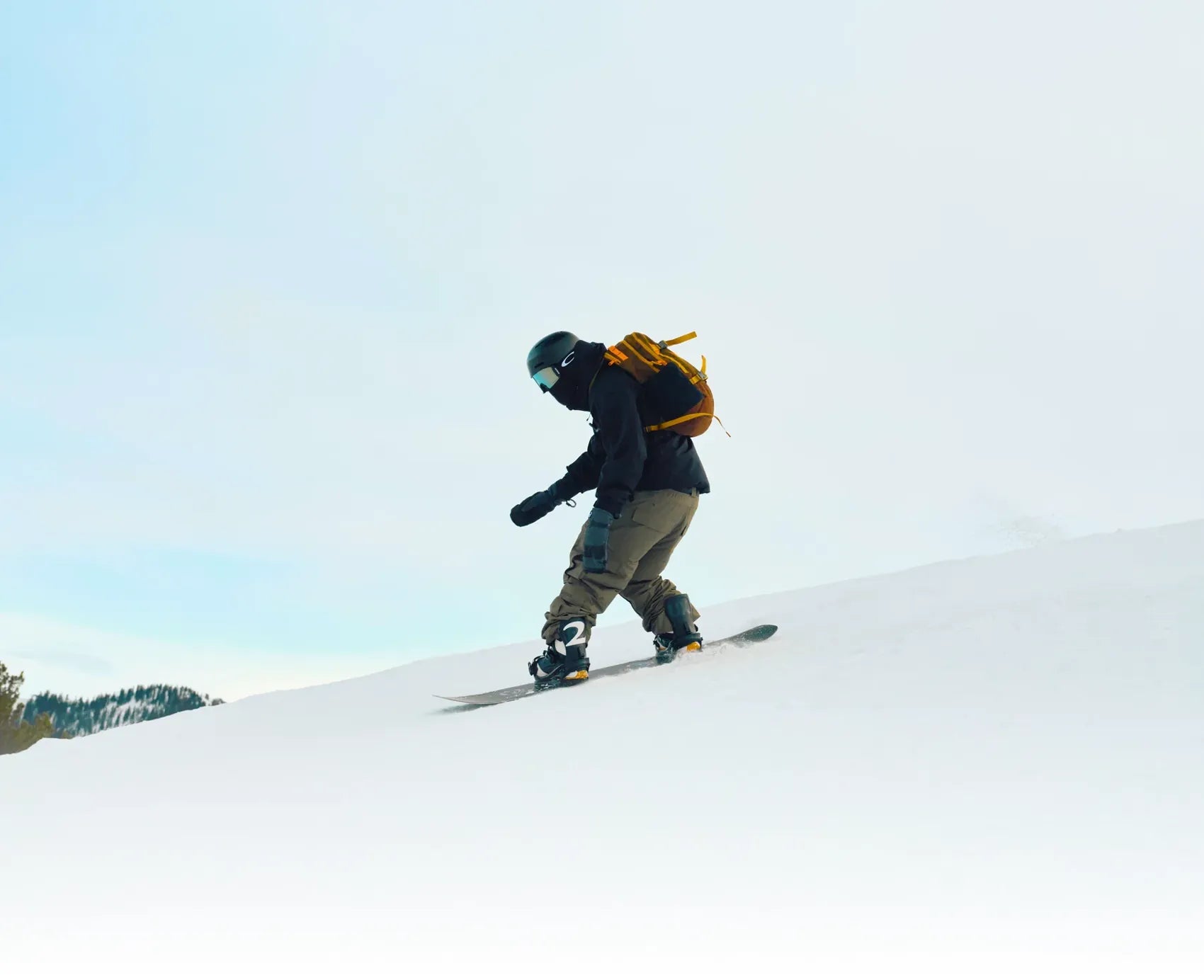 Snowboarder traversing a bright slope