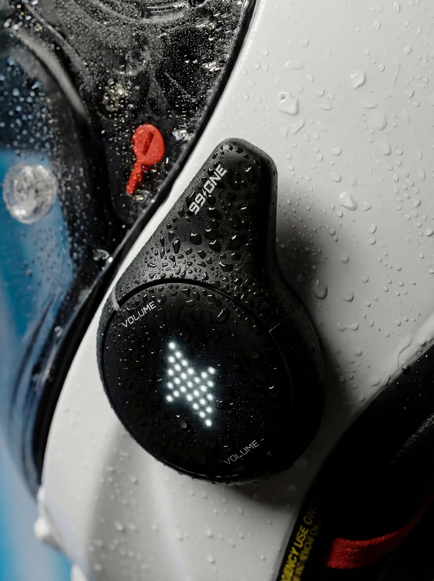 99ONE Rogue in Shadow Black, beaded with rain on a white helmet